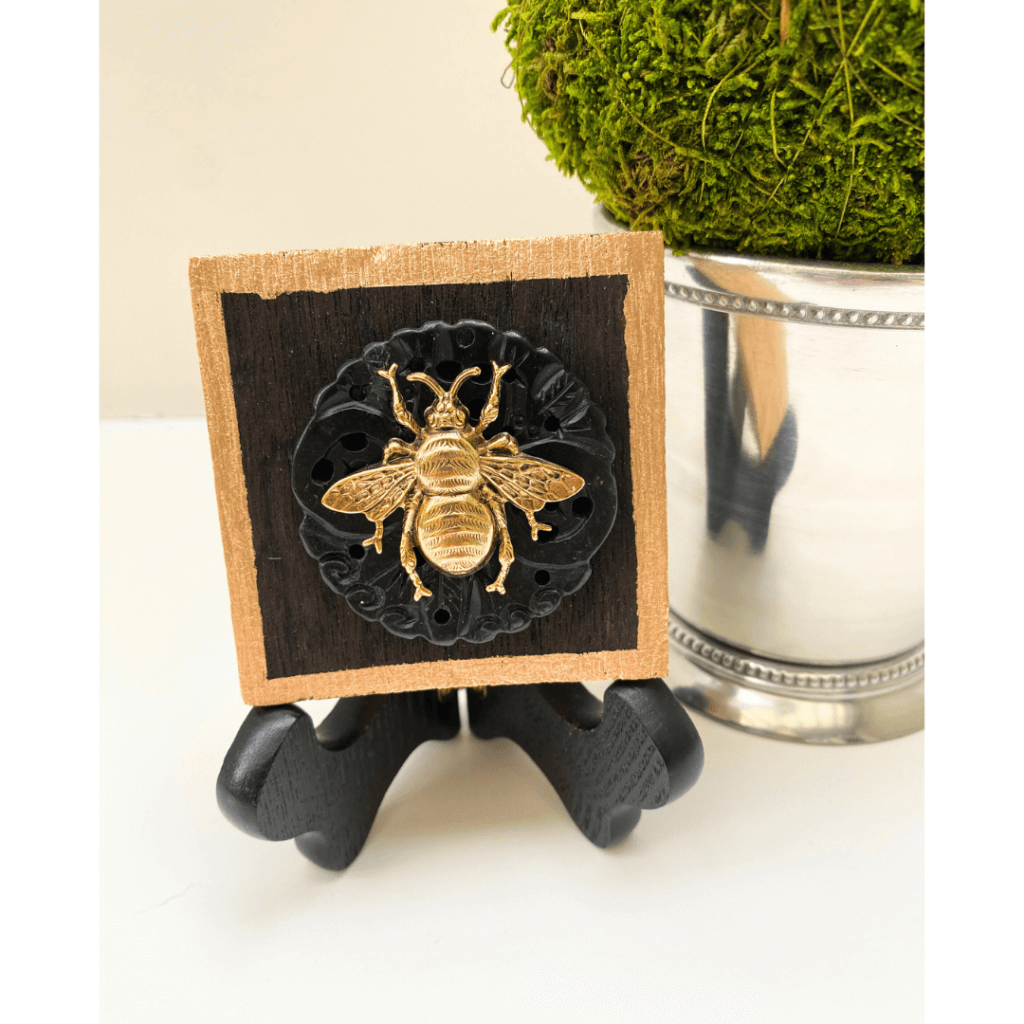 gold bee on jade and wooden art